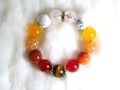 Tiger eye and various quartz lucky stone bracelet in red and white tone on white wool texture background