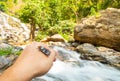 Tiger moth on man`s hand nearby waterfall