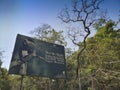 A tiger, Panthera tigris, on the sign board at Karnataka tiger reserve. The road goes through deep forest of the famous tiger Royalty Free Stock Photo