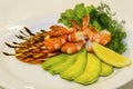 Tiger prawns with fruit and green.