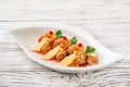 Tiger prawns with red caviar in a restaurant close-up. Fried shrimp on mashed potatoes on a white plate and copy space Royalty Free Stock Photo