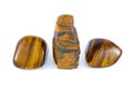 Tiger's eye rough and tumbled close up white background