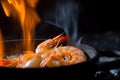 tiger shrimp prawn sizzling in a pan, with its shell on fire Royalty Free Stock Photo