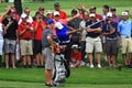 Tiger Woods hits near the crowd