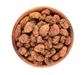 Tigernuts isolated on white background. Chufa nuts or tiger nuts in wooden bowl. Top view