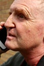 Middle aged man on phone tight close up.