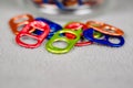Tight close up view of a number of multi colored can pull tabs lying loose Royalty Free Stock Photo