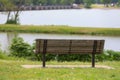 Tight crop of park bench on lake