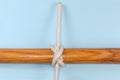 Tightened rope Cross constrictor knot on a blue background
