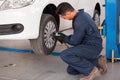 Tightening bolts of a tire Royalty Free Stock Photo