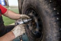 Tightening bolts on wheels of cars in the workshop