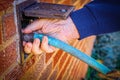 Tightening up the hose to water in spring - man`s hand screwing hose to old fashioned outdoor covered water outlet - selective Royalty Free Stock Photo