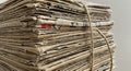 A tightly bound stack of newspapers secured with a coarse twine, showcasing neatly Royalty Free Stock Photo