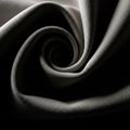 Tightly curled fabric creates a spiral pattern, light highlighting its texture Royalty Free Stock Photo
