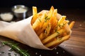 tightly packed french fries in a wax paper cone