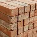 A tightly stacked pile of rectangular clay bricks, displaying a rough texture and natural Royalty Free Stock Photo