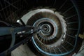 Tightly winding cement spiral staircase inside of a lighthouse with a blue railing perspective looking down from the top