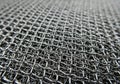 Tightly woven metal mesh with a uniform grid pattern, composed of Royalty Free Stock Photo