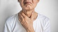 Tightness at the neck of Asian man. Concept of sore throat, pharyngitis, laryngitis, esophagitis, thyroiditis, dysphagia, choking Royalty Free Stock Photo