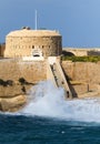 Tigne point, Malta, with waves crashing on the shore