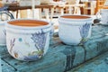 TIHANY, HUNGARY - AUGUST 05, 2017: Bright white textured hand-made pots with hand-painted bouquets of lavender and butterflies on Royalty Free Stock Photo