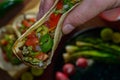 Tijuana tacos, lifting grilled carne asada taco