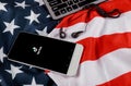 Tik Tok application icon on smartphone screen American flag waving with modern smartphone with blank screen, black headphones Royalty Free Stock Photo