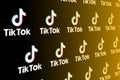 Tik Tok icon on a black background. Popular mobile app for creating and watching short videos.