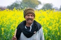 Indian farmer standing in agricultural field.