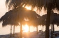 Tiki hut umbrellas, thatch. Sunrise view on beach in Tunisia. Sousse