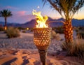 Tiki torch burning in sand dune desert landscape at sunset Royalty Free Stock Photo