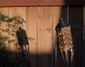 Tiki torch shadow on the fence