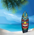 Tiki warrior mask design surfboard on ocean beach Royalty Free Stock Photo