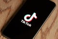 TikTok application icon on Apple iPhone 11 screen close-up.