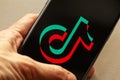 TikTok application icon on Apple iPhone 11 screen close-up. Royalty Free Stock Photo