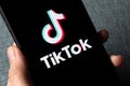 TikTok application icon on Apple iPhone 11 screen close-up. Royalty Free Stock Photo