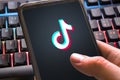 Tiktok logo with colorful background on smartphone. Social network for videos for young people close up. Verona, 13-02-21