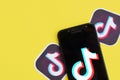 Tiktok logo on samsung smartphone screen on yellow background. TikTok is a popular video-sharing social networking service owned Royalty Free Stock Photo