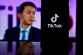 TikTok logo on screen and Tik Tok CEO Shou Zi Chew on blurred background Royalty Free Stock Photo