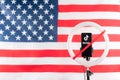 Tiktok logo on a smartphone, mounted on a round lamp with a tripod against the background of the American flag. Russia, Kazan -