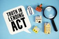 TILA Truth in Lending Act text with house models on blue background Royalty Free Stock Photo