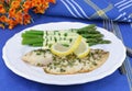 Tilapia fillets with a side of asparagus hollandaise.