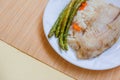 Tilapia sea fish with rice and green asparagus on a white thai. Healthy eating Royalty Free Stock Photo