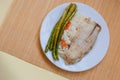 Tilapia sea fish with rice and green asparagus on a white thai. Healthy eating Royalty Free Stock Photo