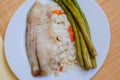 Tilapia sea fish with rice and green asparagus on a white thai. Healthy eating Royalty Free Stock Photo