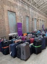 Cruise passengers luggage at a collection point in a cruise terminal.