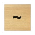 Tilde operator sign on wood block Royalty Free Stock Photo