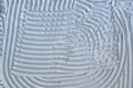 Tile adhesive notched trowel patterns. Adhesive background. Royalty Free Stock Photo