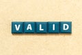 Tile letter in word valid on wood background Royalty Free Stock Photo