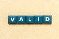 Tile letter in word valid on wood background